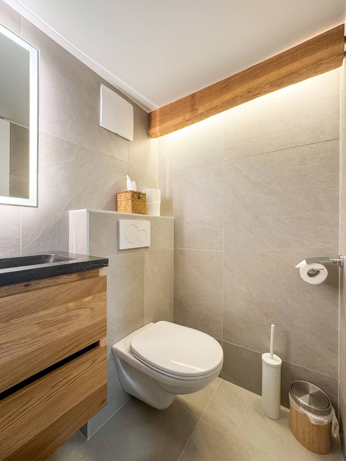 Modern bathroom with wall-hung toilet and warm tiling