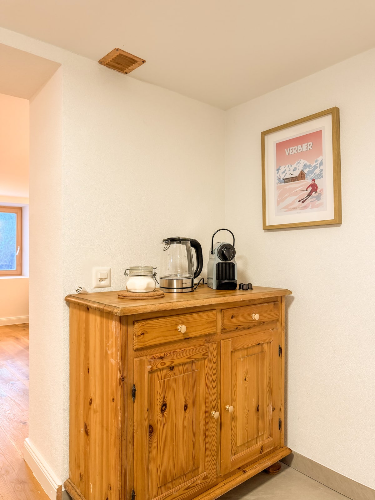 Sideboard with kettle and a Verbier poster